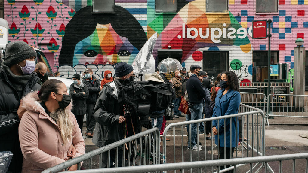 A small crowd gathers at NYPD barricades during the Macy's Thanksgiving Day Parade