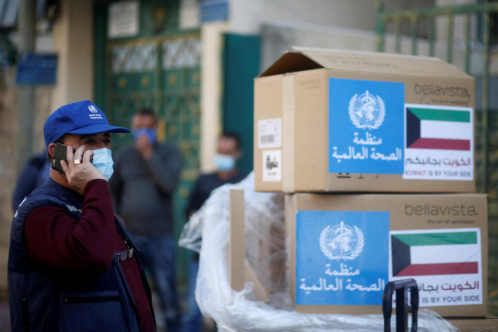 Abdelnaser Soboh, Emergency Health Lead in the World Health Organization's Gaza sub-office, stands next to boxes containing ventilators delivered by the World Health Organization (WHO) and donated by Kuwait, in Gaza City 