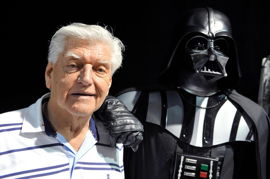 David Prowse appears with Darth Vader, his most iconic role, at a Star Wars convention in Cusset, central France, April 2013 