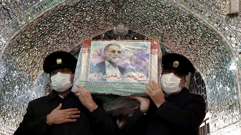 Servants of the holy shrine of Imam Reza carry the coffin of Iranian nuclear scientist Mohsen Fakhrizadeh, in Mashhad, Iran 