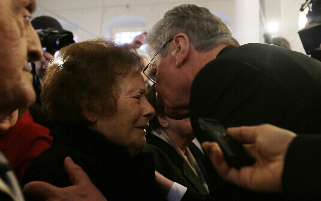 German President Joachim Gauck, right, kisses 93-year-old Esther Cohen,, a Greek Jewish death camp survivor, during his visit at a synagoge in Ioannina, northwestern Greece, on March 7, 2014