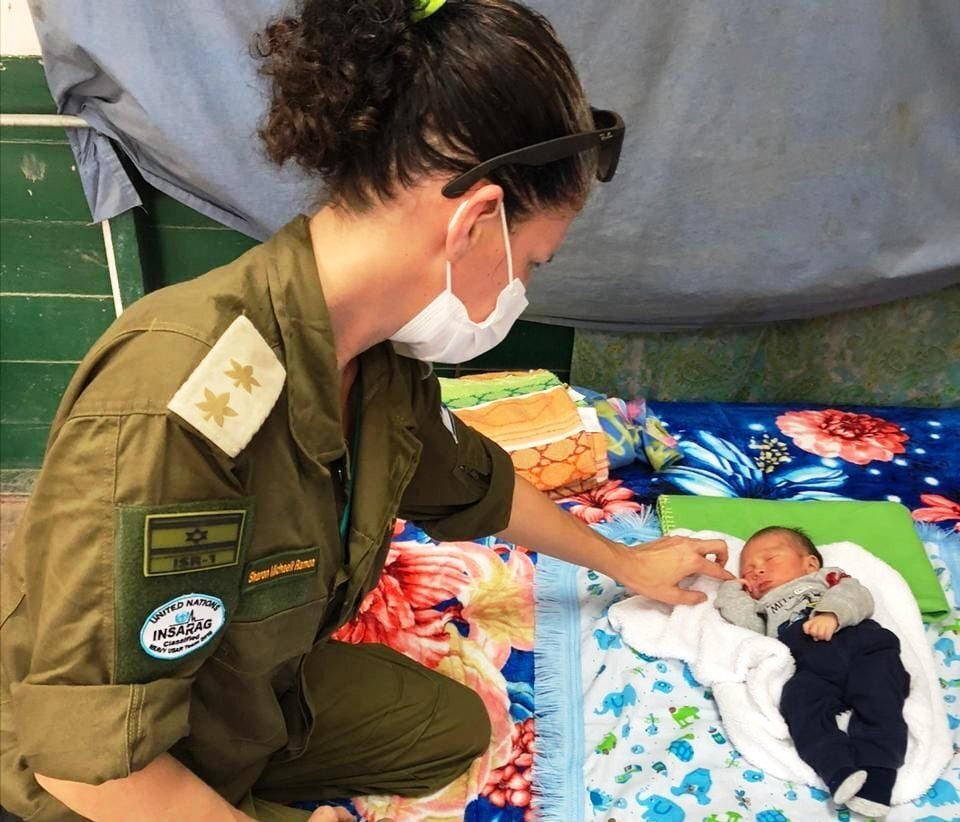 An IDF Home Front Command officer assisting people left homeless in Honduras following storms Eta and Iota 