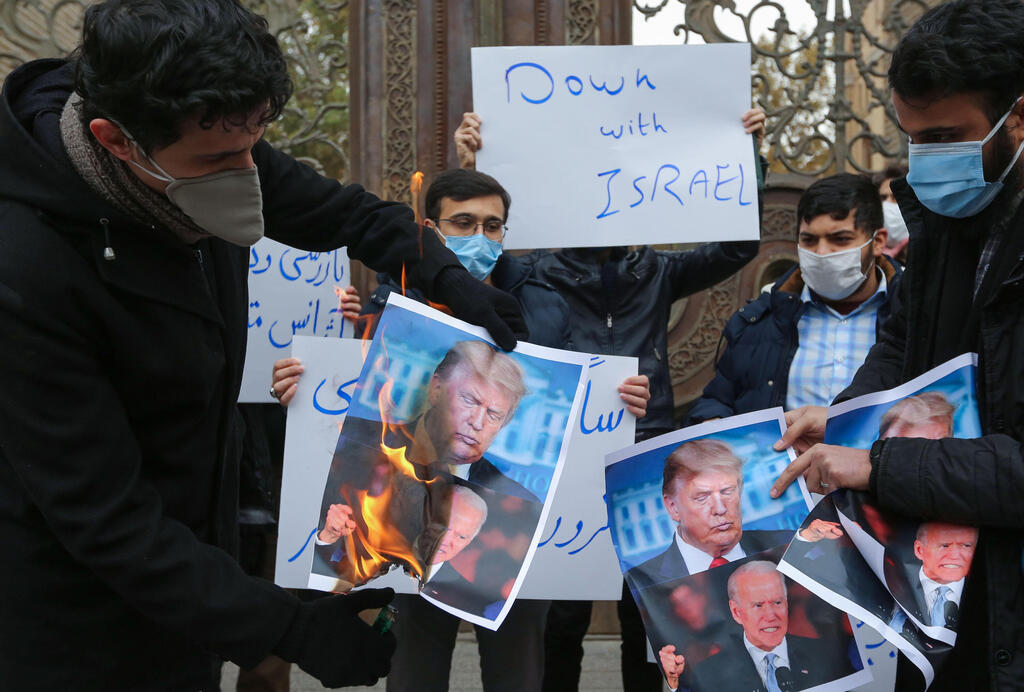 Protesters burn images of Donald Trump and Joe Biden at a rally in Tehran over the killing of nuclear scientist Mohsen Fakhrizadeh, Nov. 2020 