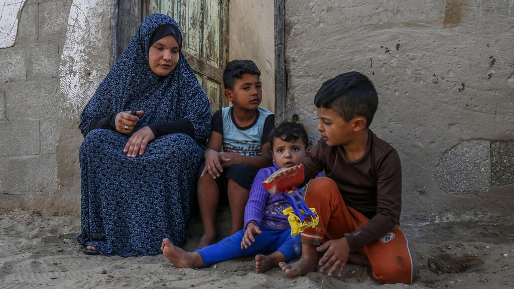 The family of Iranian Qasem Sheyasi outside their home in Khan Yunis in the Gaza Strip