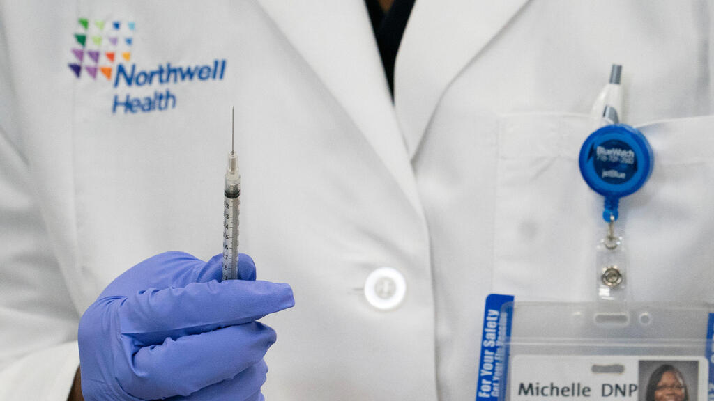 Dr. Michelle Chester holds a syringe of the coronavirus diseases (COVID-19) vaccine