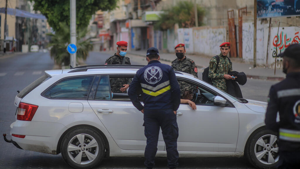 Palestinian policemen stand guard in an empty street during a complete closure amid the ongoing COVID-19 coronavirus pandemic in Gaza City, 12 December 2020