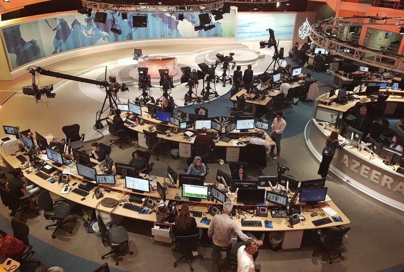 Al-Jazeera staff work at their TV station in Doha, Qatar 