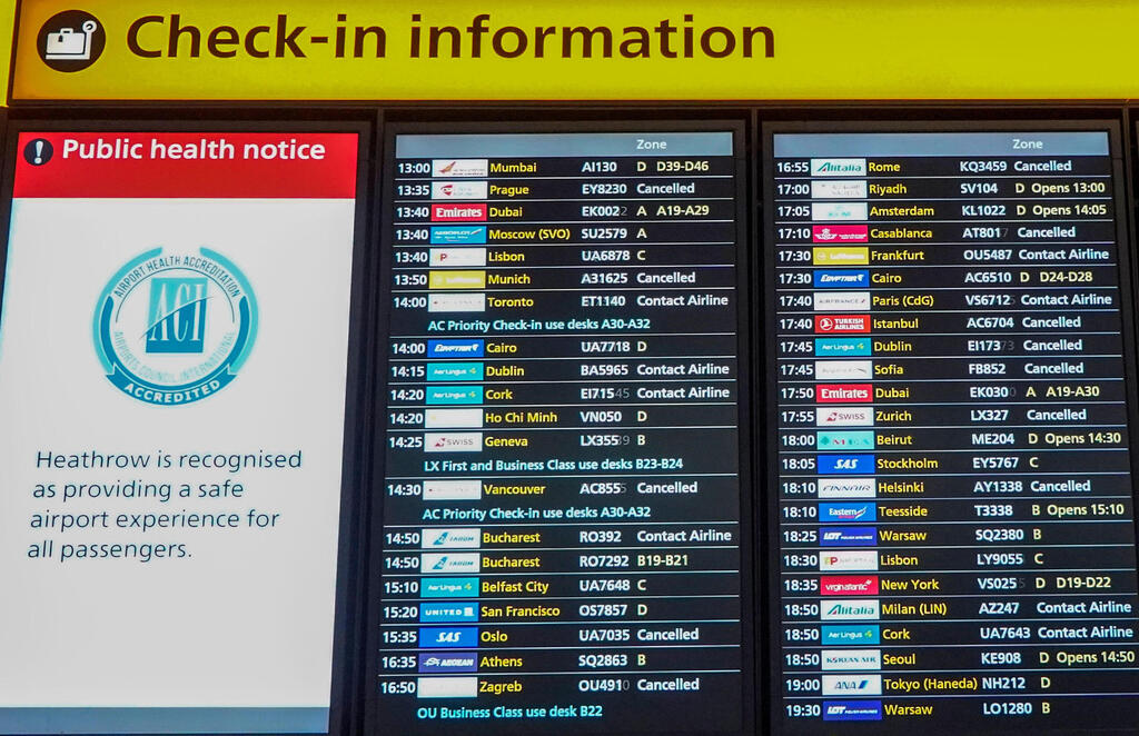 An electronic information display board shows the "cancelled" status of flights, including those bound for Dublin, Istanbul, and Munich among others, in the departures hall at Terminal 2 of Heathrow Airport in west London on December 21, 2020, as a string of countries around the world banned travellers arriving from the UK,