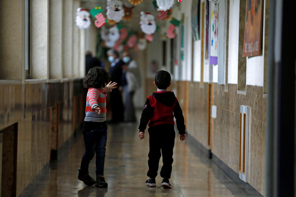 Children walk at The Creche, a house sheltering children, in Bethlehem
