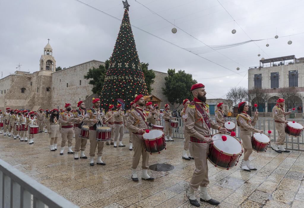 Palestinian scout bands parade through Manger Square at the Church of the Nativity, traditionally recognized by Christians to be the birthplace of Jesus Christ, ahead of the midnight Mass,