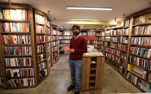 Manager Reza Bahrami poses for a picture at a bookstore of the Nashre-Cheshmeh Publishing House on Karim Khan street in the Iranian capital Tehran 