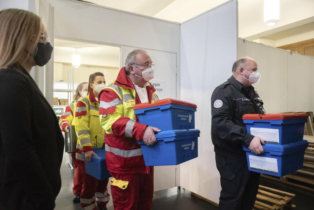 A mobile vaccination team receives the vaccines for the Covid 19 vaccinations at the pharmacy of the vaccination centre in the Festhalle in Frankfurt, Germany 