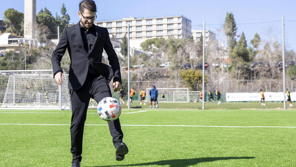 Moshe Hogeg, one of the owners of Beitar Jerusalem FC soccer club, plays with a ball, in the team training ground in Jerusalem 