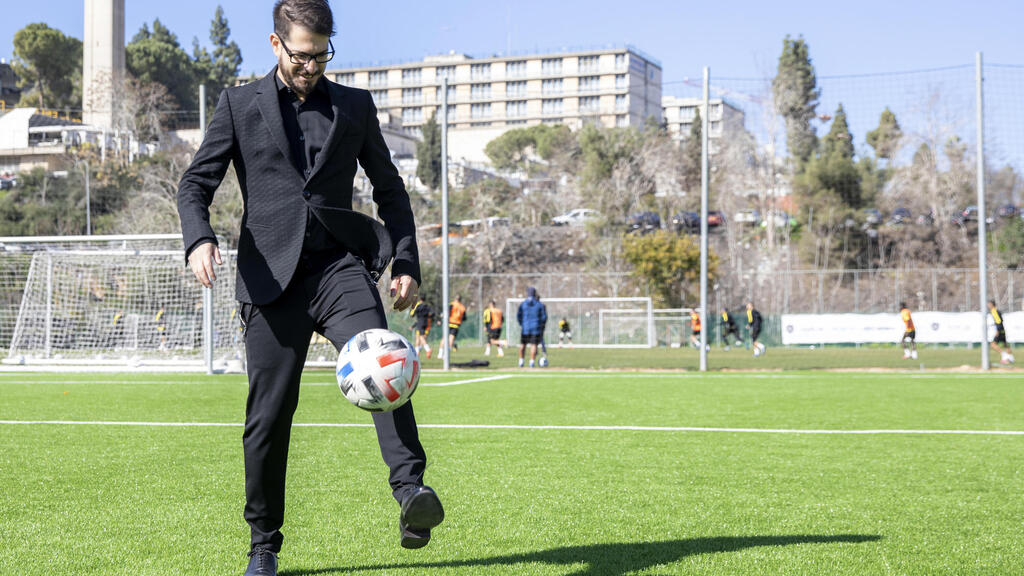 Moshe Hogeg, one of the owners of Beitar Jerusalem FC soccer club, plays with a ball, in the team training ground in Jerusalem 