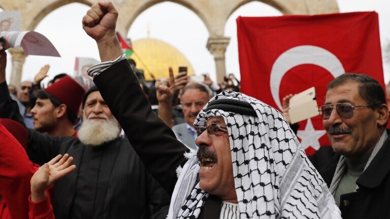 A Turkish flag is raised in a Palestinian demonstration in East Jerusalem 