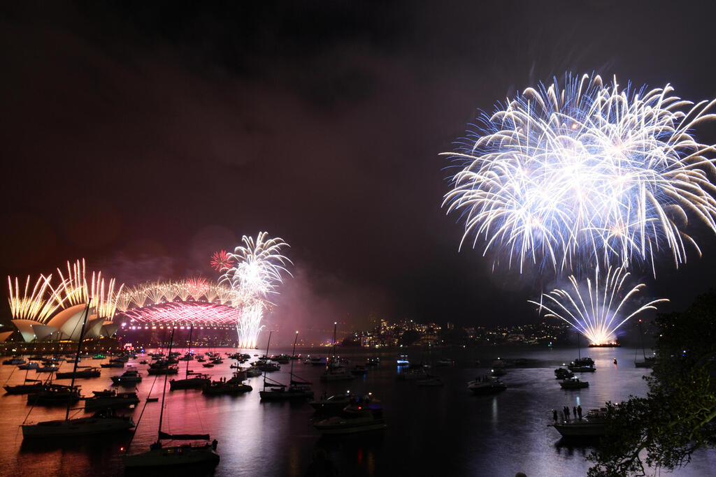 Fireworks explode over the Sydney Opera House and Sydney Harbor Bridge 