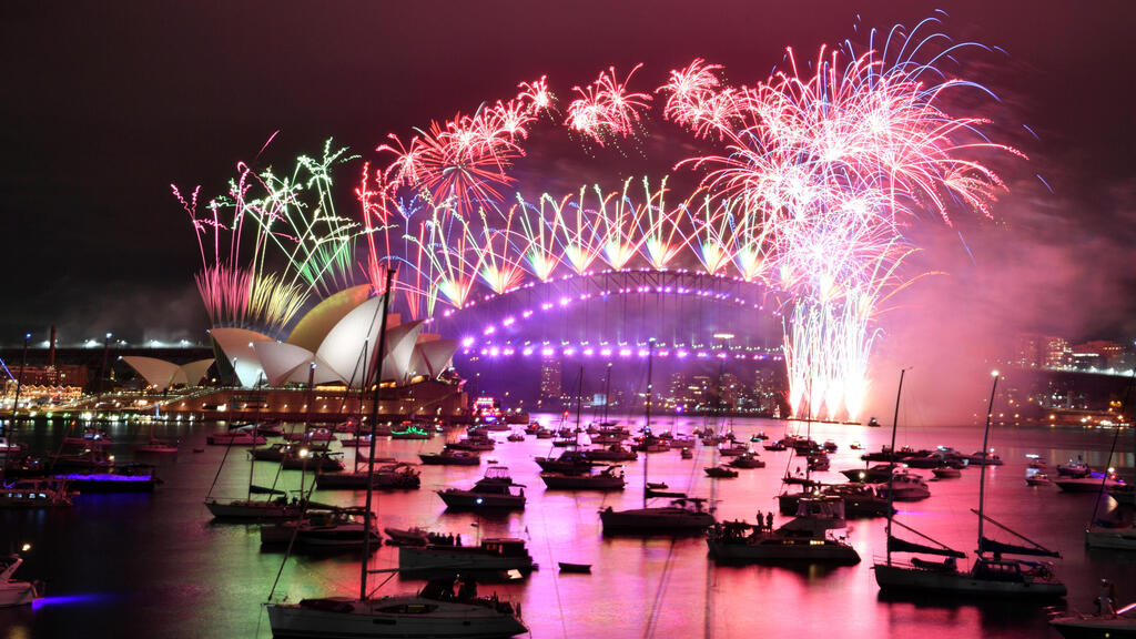Fireworks explode over the Sydney Opera House and Sydney Harbour Bridge 
