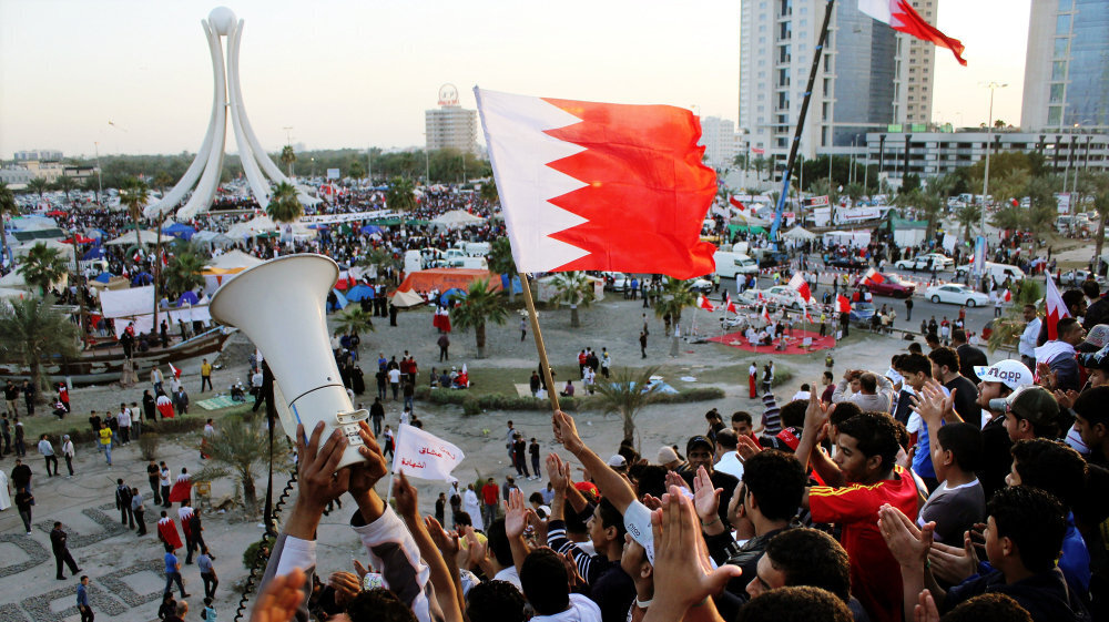 Protesters wave flags at the Pearl Roundabout in the capital Manama on Feb. 20, 2011