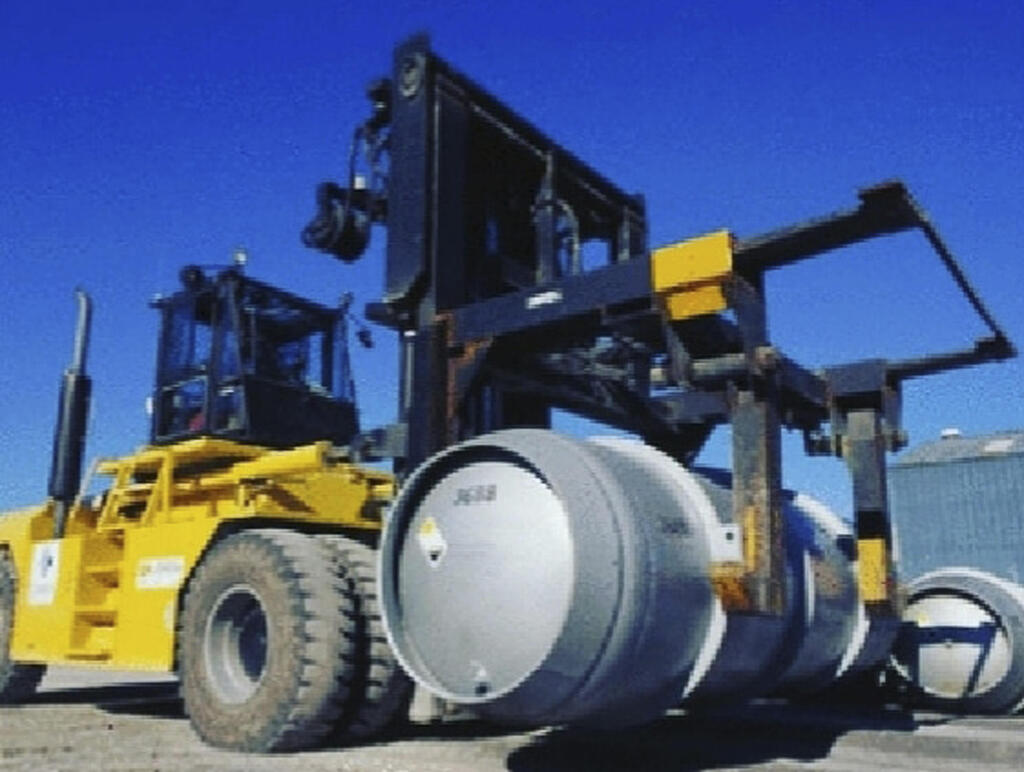 a forklift carries a cylinder containing uranium hexafluoride gas for the purpose of injecting the gas into centrifuges in Iran's Fordo nuclear facility