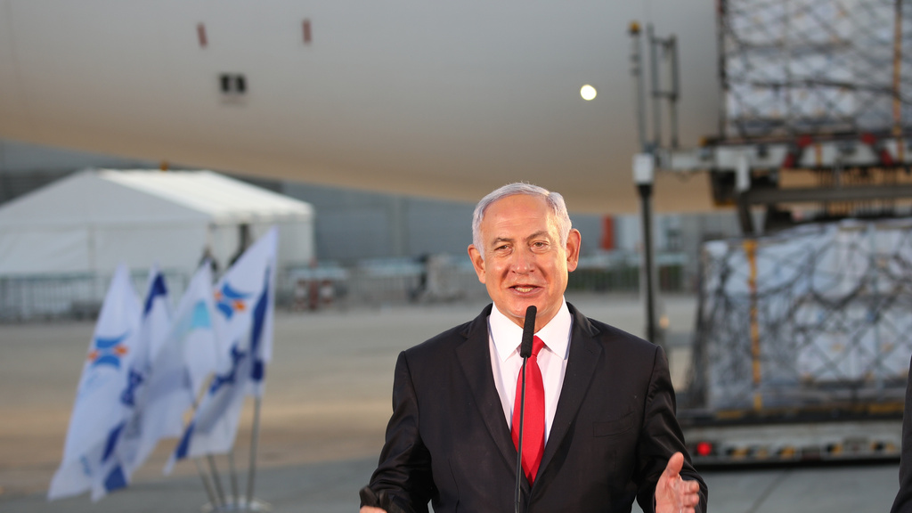  Prime Minister Benjamin Netanyahu greets a plane delivering coronavirus vaccines to Israel in January 