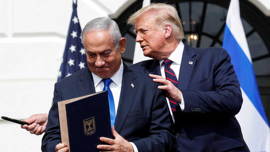 Prime Minister Benjamin Netanyahu stands with US President Donald Trump after signing the Abraham Accords, at the White House 