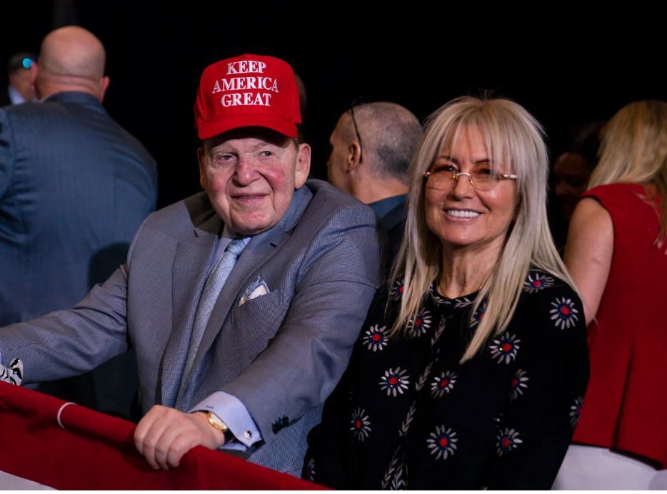 Sheldon Adelson in a MAGA hat with his wife Miriam at a Trump rally in Las Vegas last February 