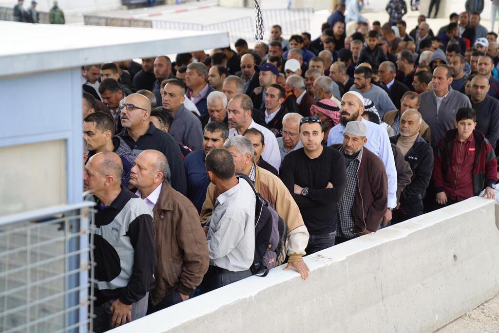 Palestinians at a border crossing near Jerusalem 