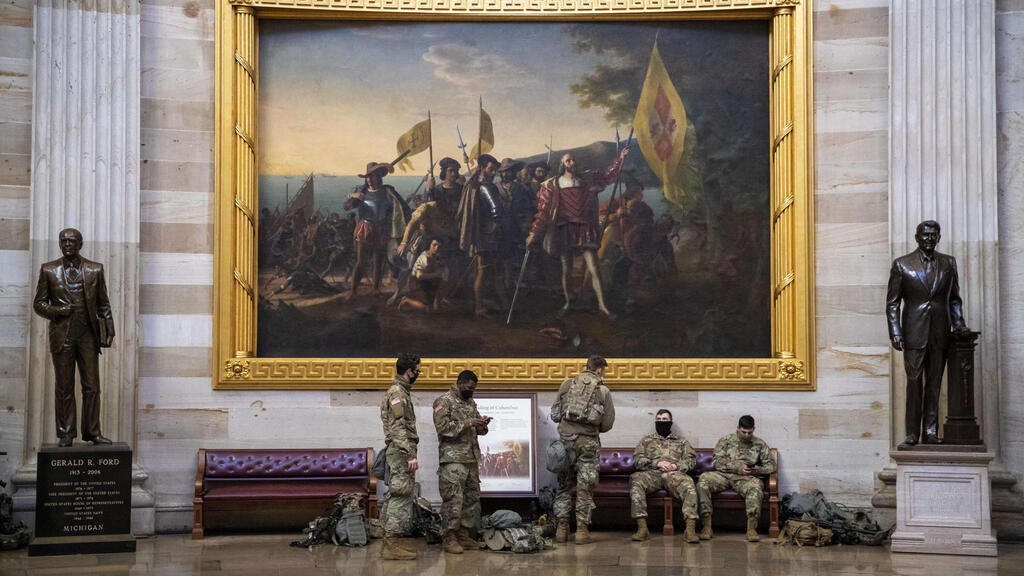 Newly deployed National Guard troops rest in the Capitol Rotunda,  Jan. 13 2021 