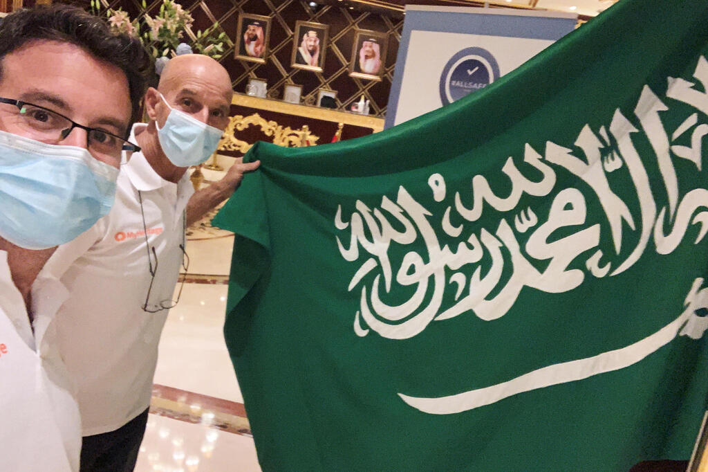 Omer Pearl and driver Danny Pearl take a selfie with a flag before the begining of the Dakar Rally, in a hotel in Jeddah, Saudi Arabia 