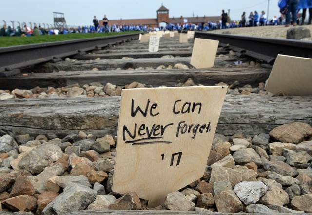 A sign is seen on the tracks at the former Nazi German Auschwitz-Birkenau death camp during the 'March of the Living' in 2015 