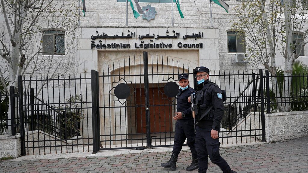 Palestinian policemen guard outside the Palestinian legislative council in Ramallah, in the Israeli-occupied West Bank, Jan. 16, 2021. 
