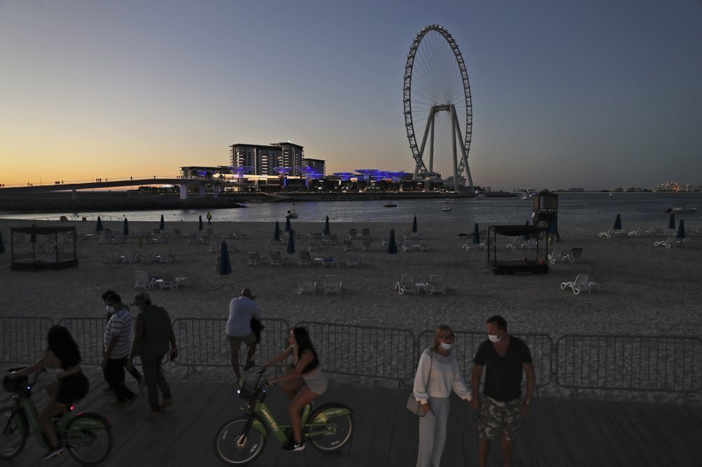 Tourists and residents enjoy the sunset at the Jumeirah Beach Residence, in Dubai, United Arab Emirates 