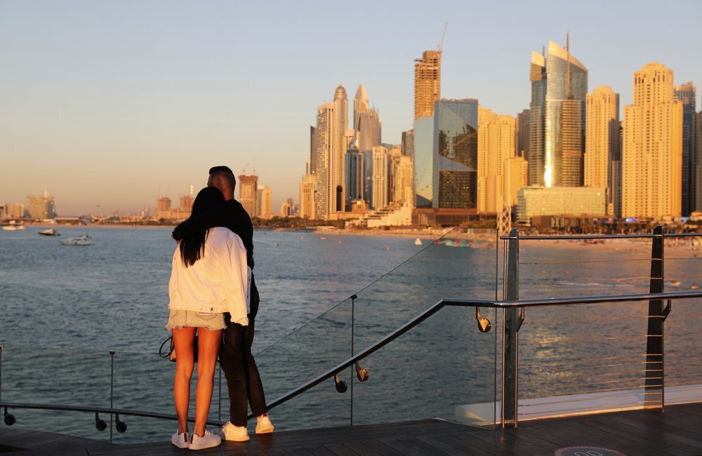 Tourists look at the skyline at sunset, in Dubai, United Arab Emirates 