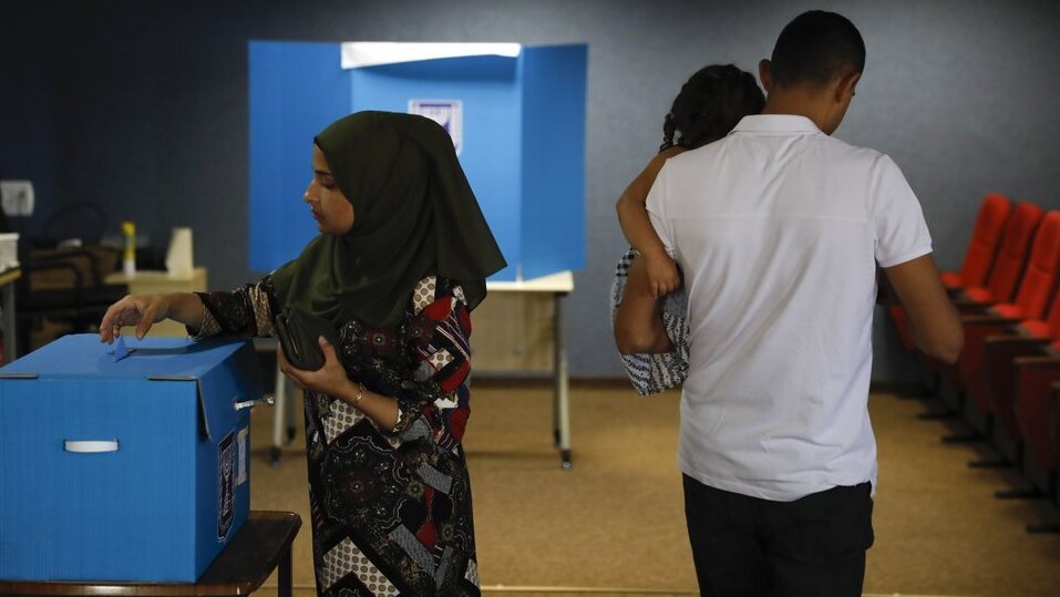 a woman votes in Kfar Manda, an Arab town in Israel 
