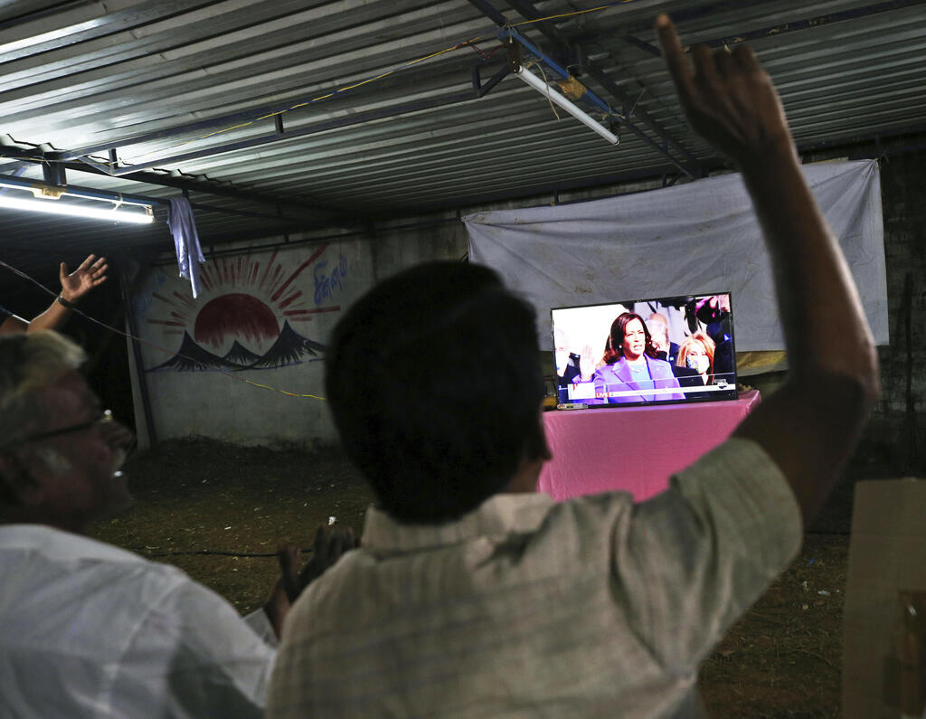 Villagers in Thulasendrapuram, the hometown of Kamala Harris' maternal grandfather, celebrate as they watch a live telecast of her being sworn in as U.S. vice president, Jan. 20, 2021 