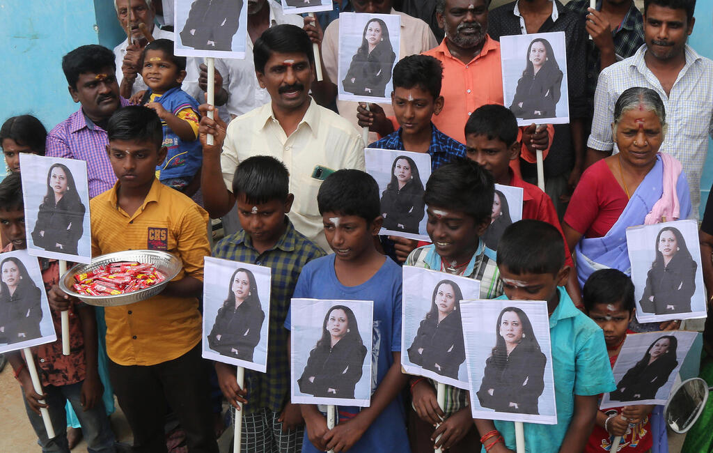 Villagers in Thulasendrapuram, the hometown of Kamala Harris' maternal grandfather, hold photos of the new U.S. vice president, Jan. 20 2021 