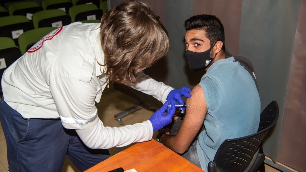A high school student receives the coronavirus vaccine in northern Israel in January (Photo: Eyal Amar) מתחסנים בג'וליס