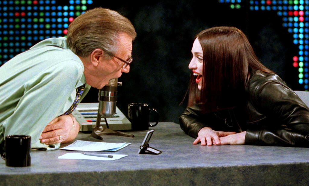 Singer Madonna shares a laugh with Larry King on the set of the CNN talk show 'Larry King Live' in New York City, Jan. 1999 
