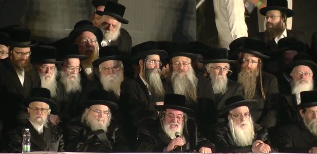 Rabbi Israel Hager, head of the Vizhnitz Hassidic dynasty (holding a microphone) with members of his flock 