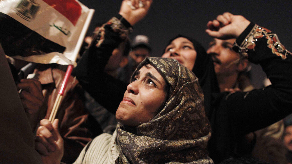an Egyptian woman cries as she celebrates the news of the resignation of President Hosni Mubarak