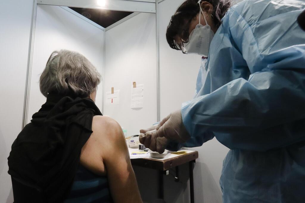 A Holocaust survivor receives an injection of the COVID-19 vaccine at a vaccination center in Vienna, Austria