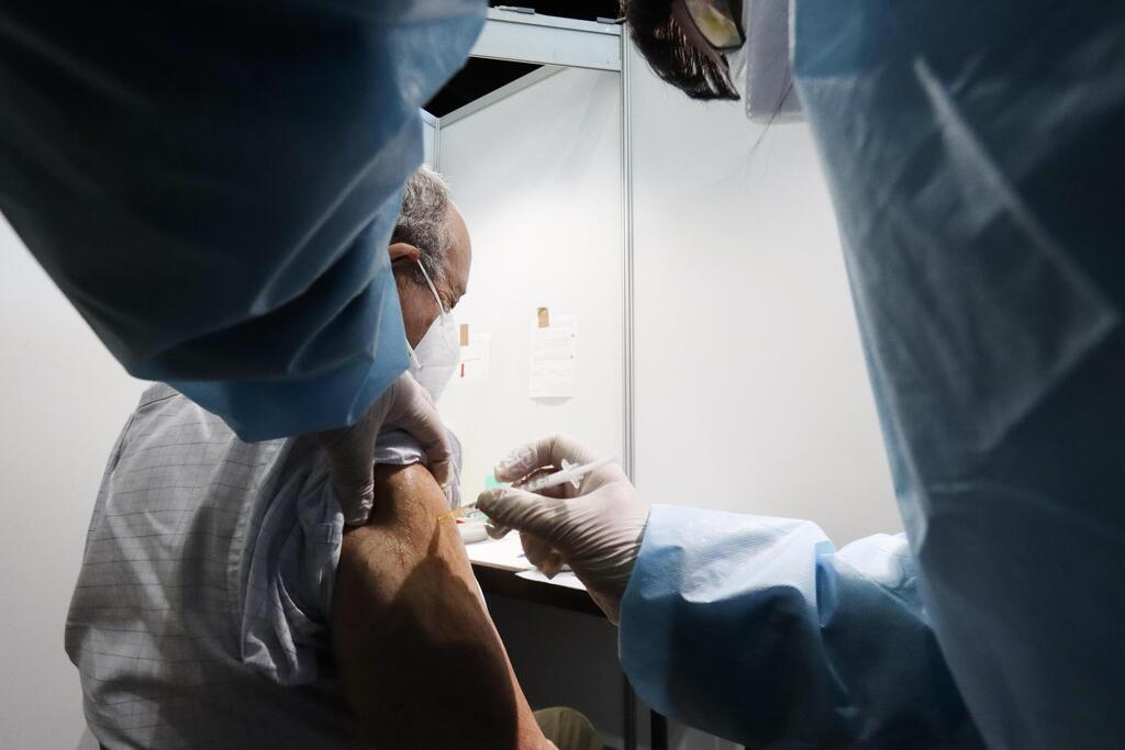 A Holocaust survivor receives an injection of the COVID-19 vaccine at a vaccination center in Vienna, Austria