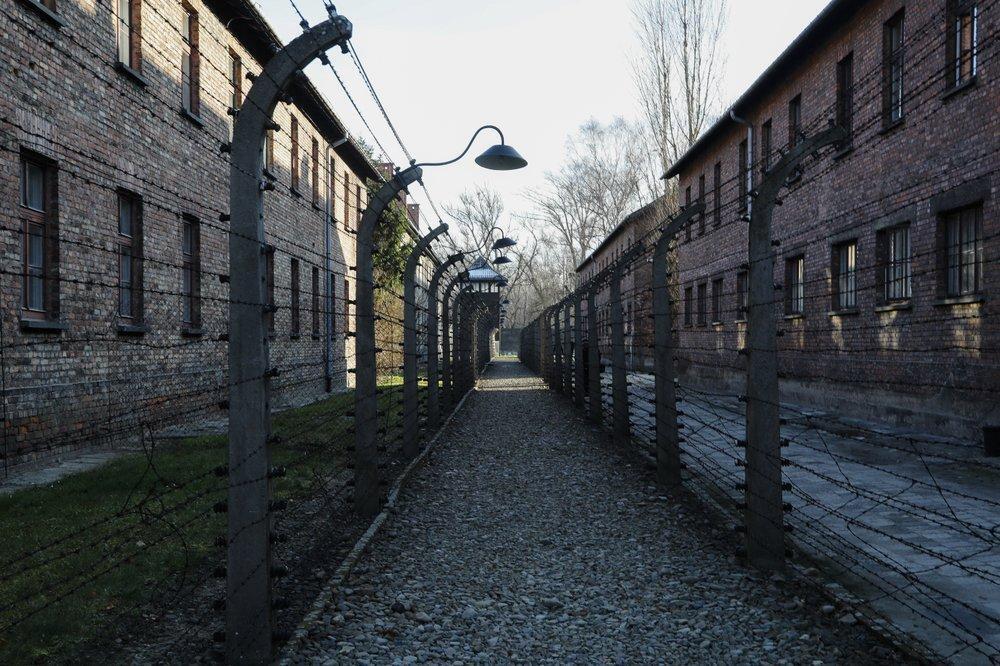 A pathway leading to an observation and security tower between what were electric barbed wire fences inside the former Nazi death camp of Auschwitz I in Oswiecim, Poland 