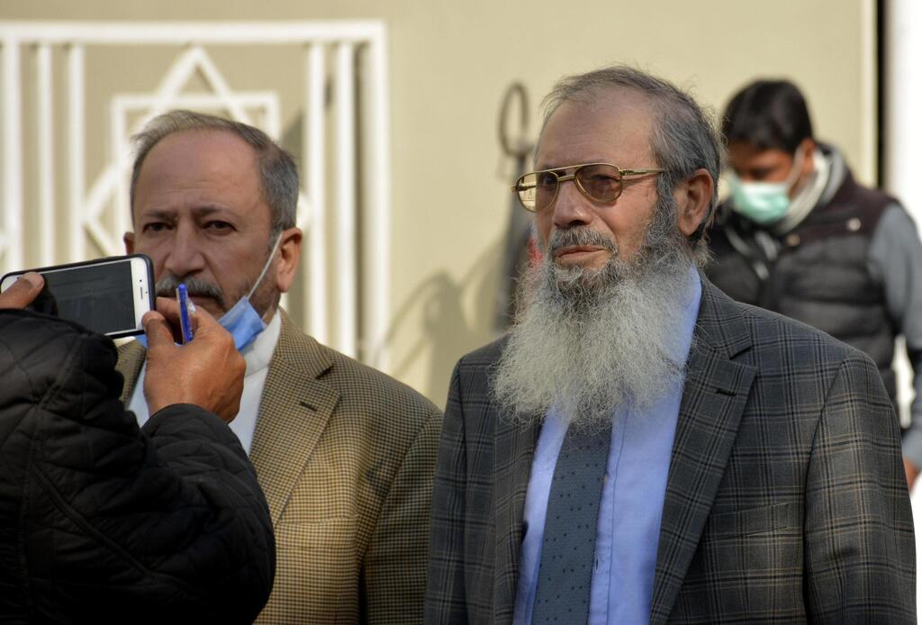 Ahmed Saeed Sheikh, right, father of British-born Pakistani Ahmed Omar Saeed Sheikh, speaks to journalists at the Supreme Court after an appeal hearing in the Daniel Pearl murder case, in Islamabad, Pakistan, Thursday, Jan. 28, 2021