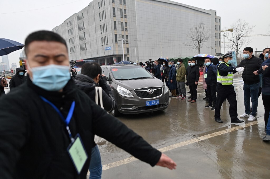 Cars transporting members of the World Health Organization (WHO) team, investigating the origins of the COVID-19 coronavirus, arrive at the closed Huanan Seafood wholesale market in Wuhan, China’s central Hubei province 