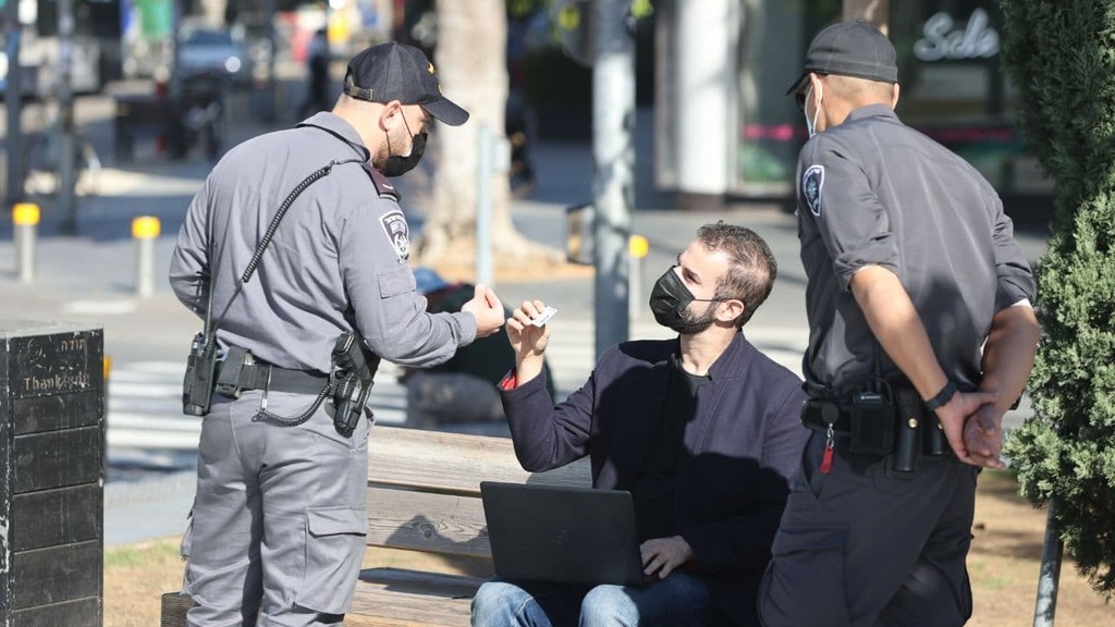 שוטרים אוכפים  את הסגר השלישי בכיכר דיזנגוף ומבקשים תעודה מחבר הכנסת יוראי להב