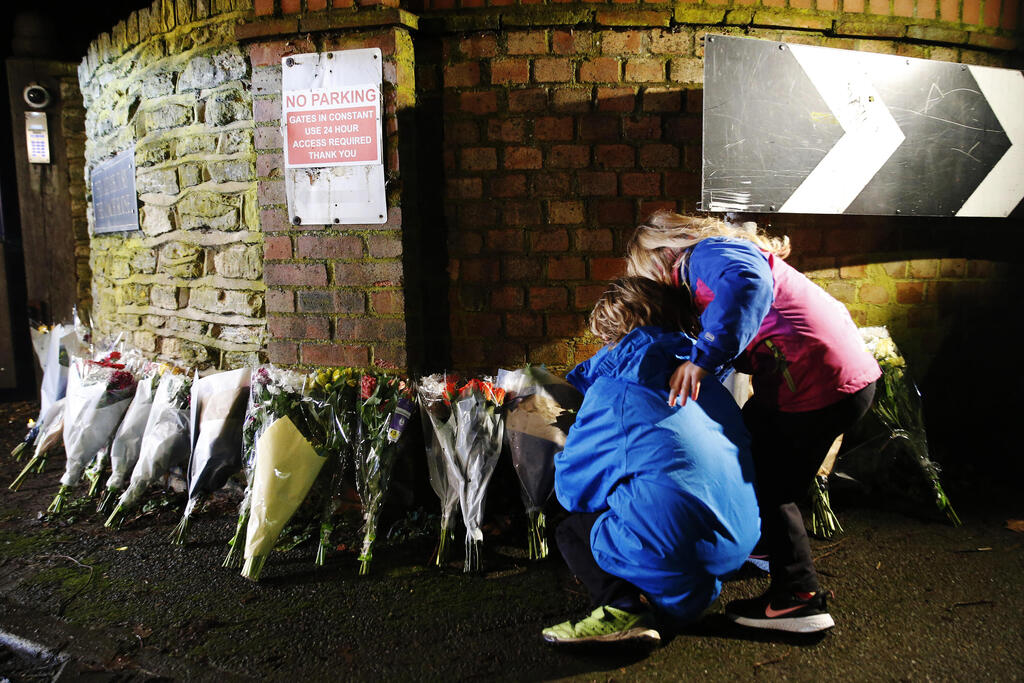 Members of the public leave flowers outside the residence of Captain Sir Tom Moore in Marston Moretaine, southern England after his death on Feb. 2, 2021 