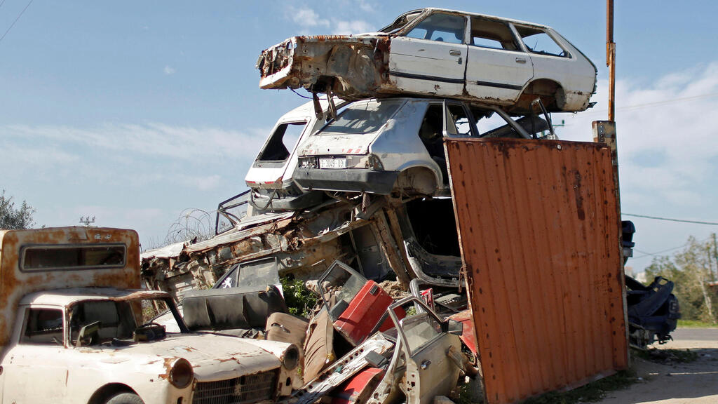 Old and broken cars are seen at scrap metal yard to be pressed in preparation for exports, east of Gaza 
