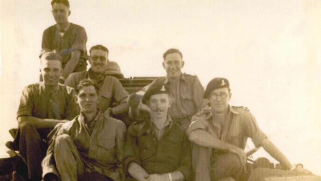 Captain Sir Tom Moore, center, poses with his comrades during his military service in India, 1942 