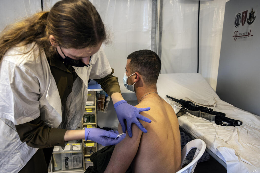 An IDF soldier receives the COVID-19 vaccine at an army base in Rishon Lezion, Feb. 2021 
